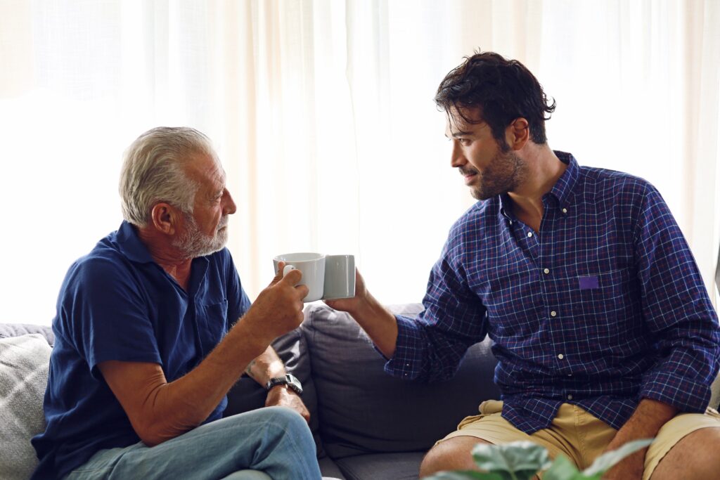 Dad and son talking about recovery during the holidays in the home.