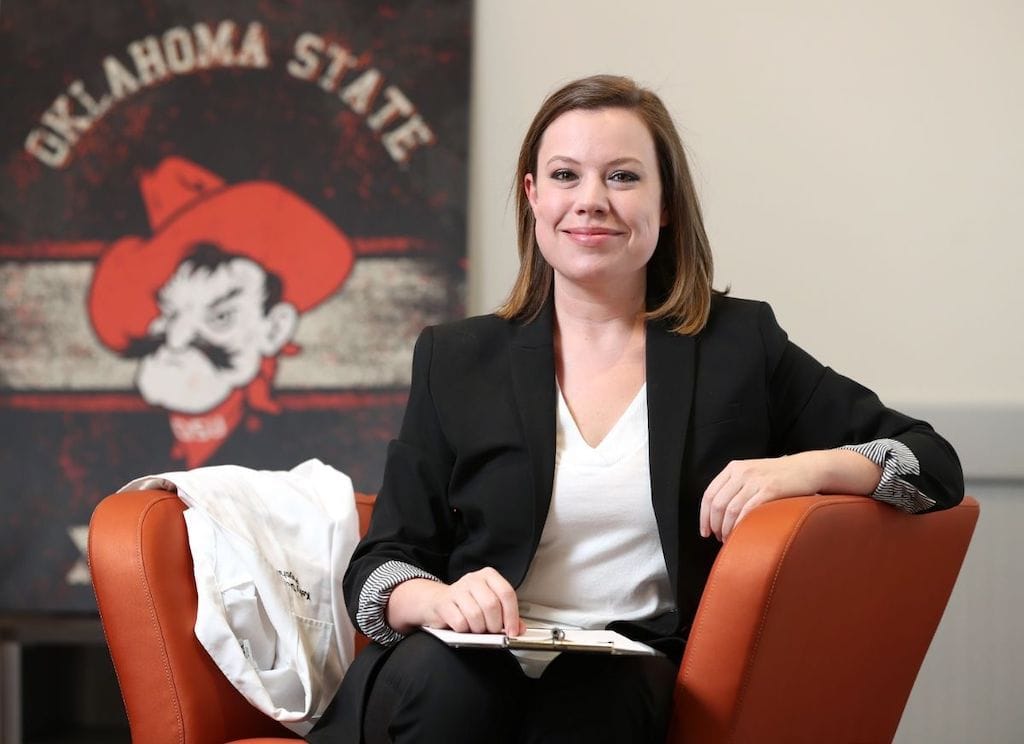 Dr. Kelly Dunn sits in a chair.