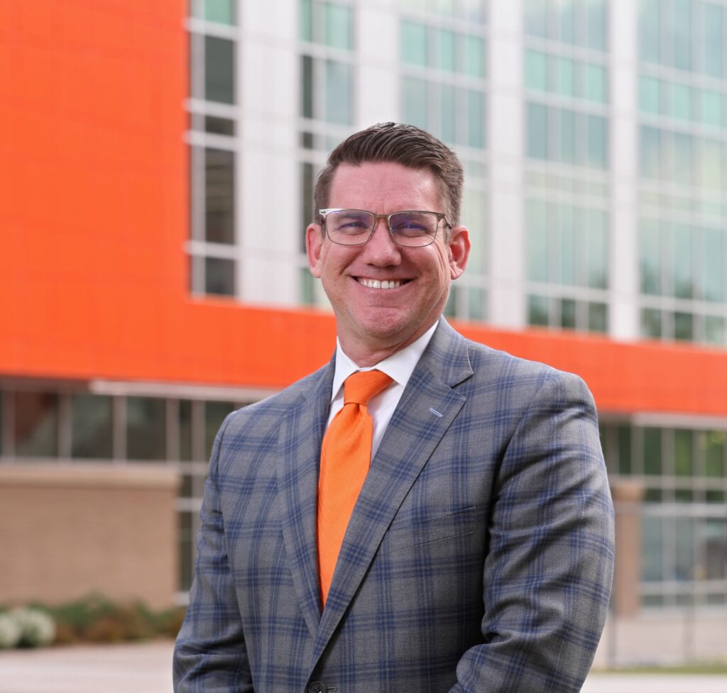 Pictured is Eric Polak. He serves as chief financial officer  of NCWR. He is also Vice President of Administration and Finance for OSU Center for Health Sciences. The picure is taken outside of the OSU Center for Health Sciences.