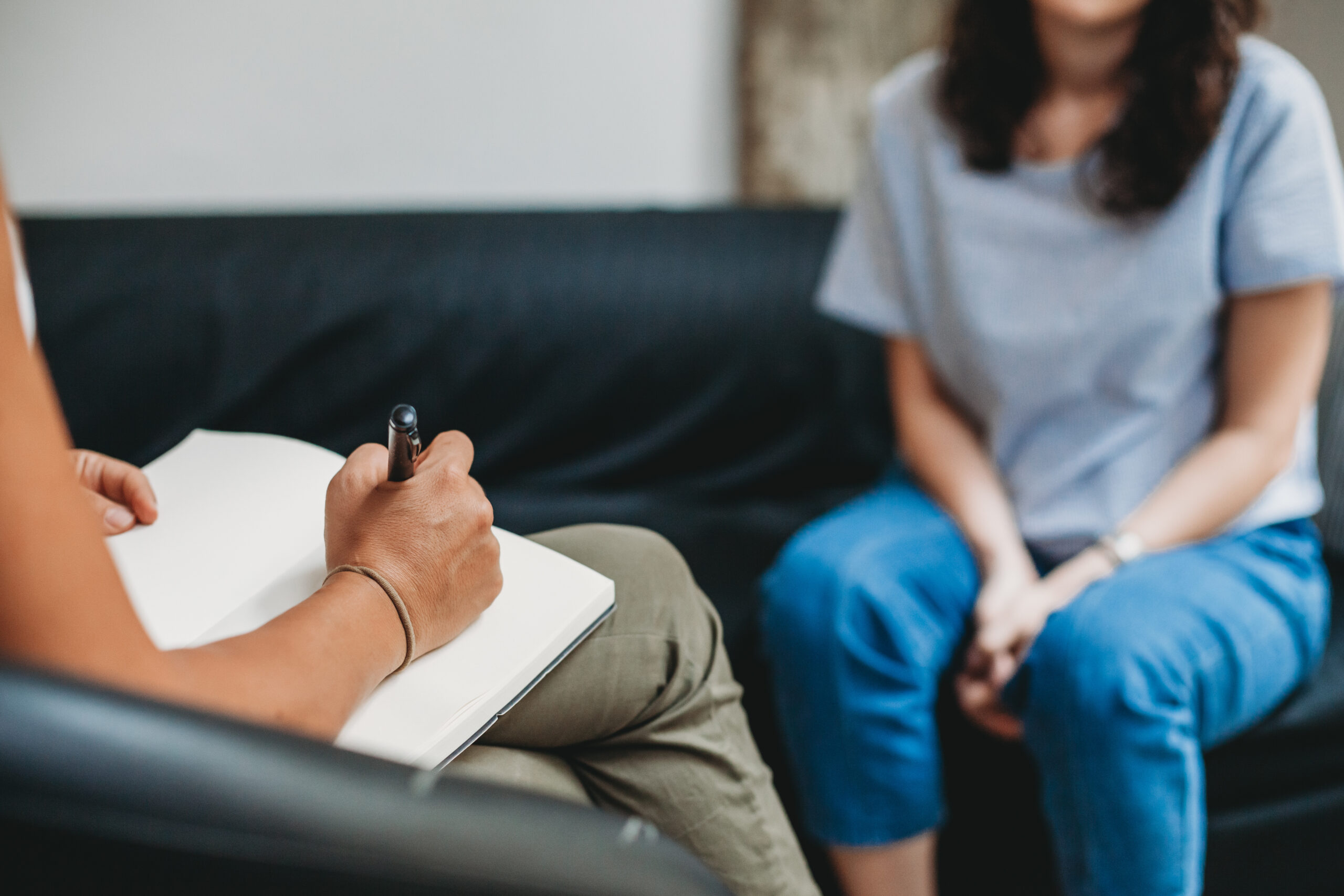 Psychotherapy session, woman talking to psychologist in counseling session.